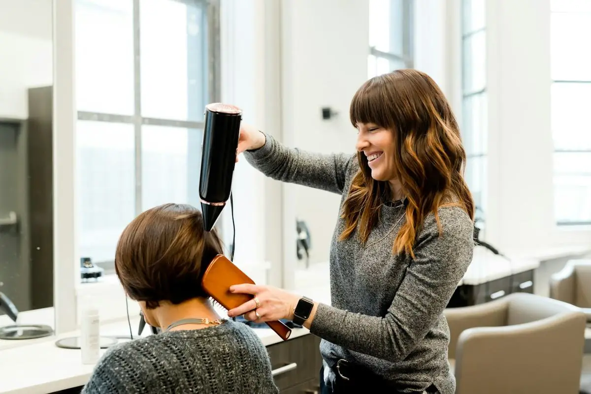 Stylist styling a client's hair